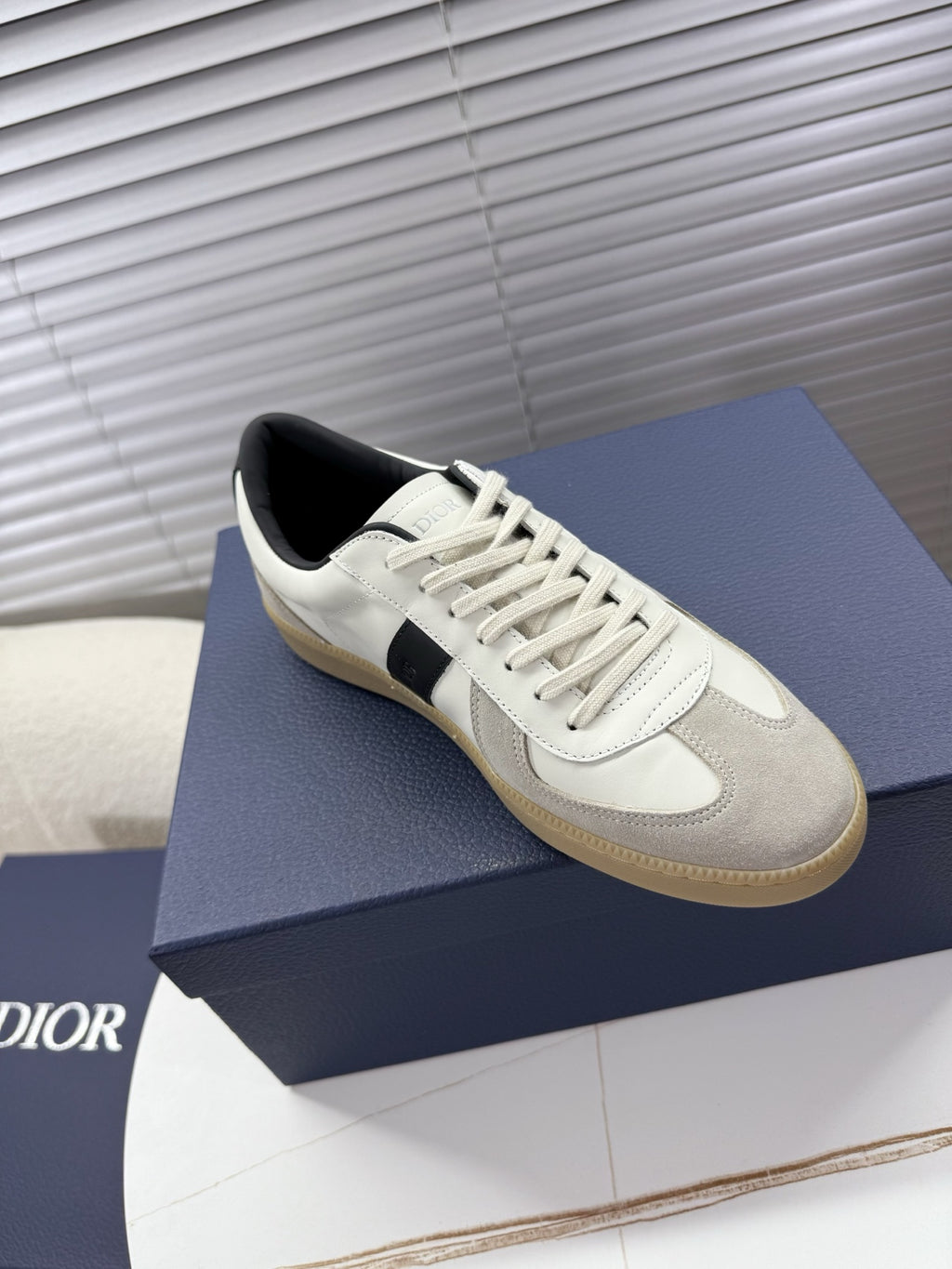 White leather sneakers with black stripe, cream sole, lace-up front, Dior emblem