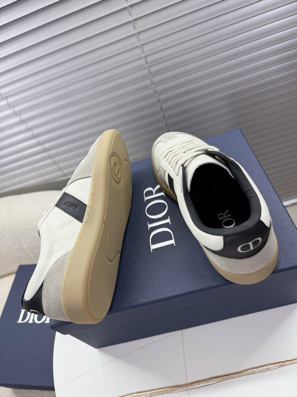 White sneakers with black interior, Dior logo on side, cream rubber sole