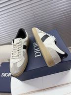 White sneakers with black stripe, cream sole, Dior logo on the tongue