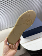 Tan outsole with Dior logo on rubber sole of sneakers