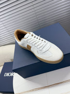 White Dior lace-up sneaker with tan side panel and gum-style sole