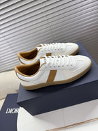 White lace-up sneakers with tan trim, side-by-side view with gum outsole