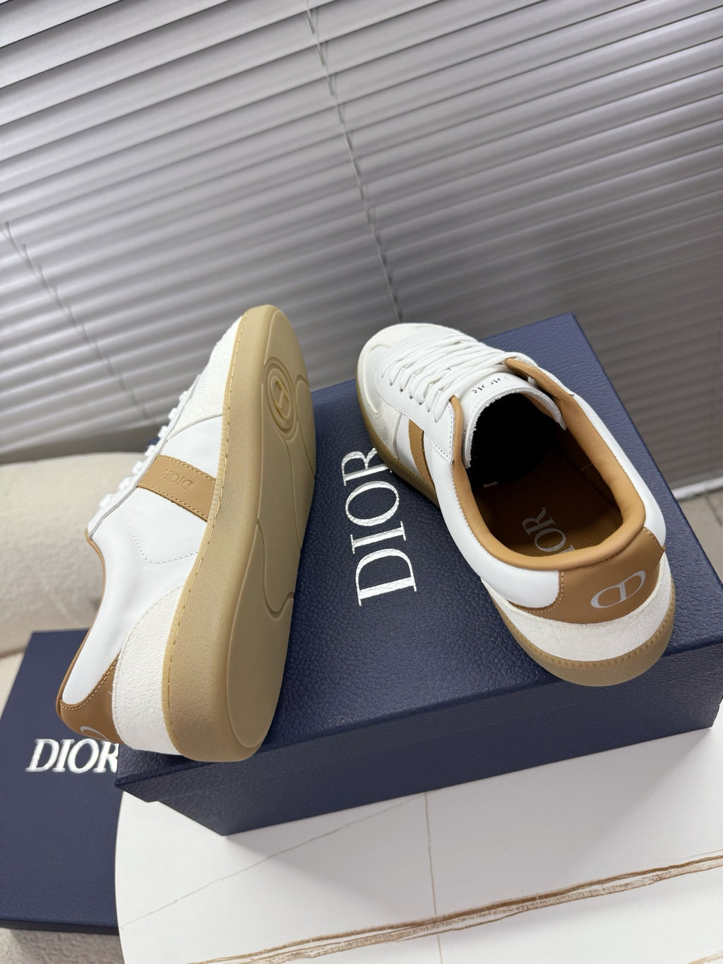 White and tan Dior sneakers with chunky gum-style rubber soles