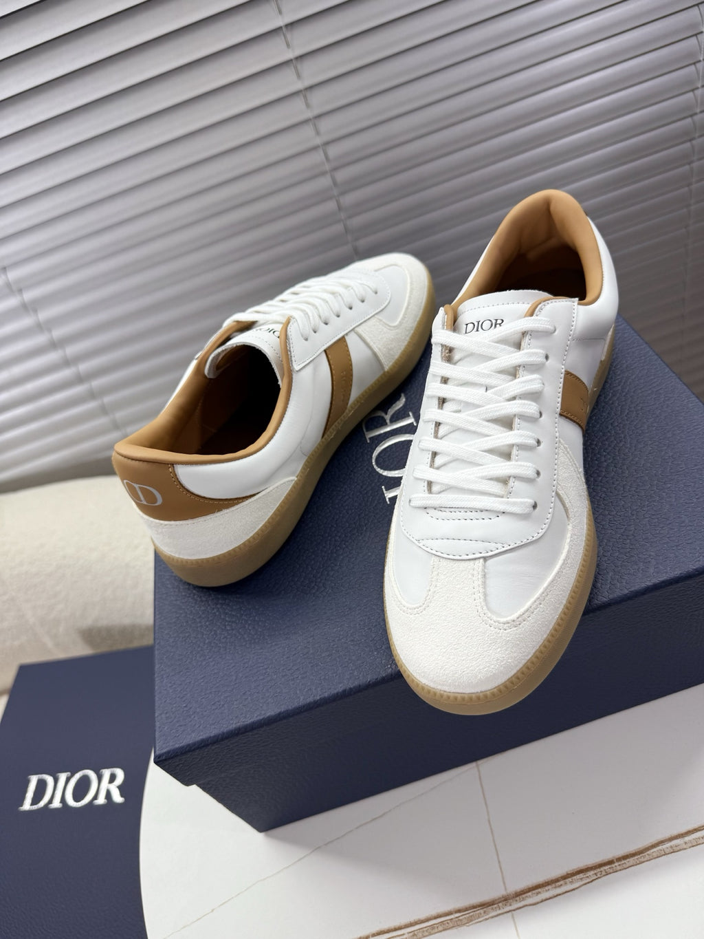 White and tan lace-up sneakers, front view with tan heel tab and gum sole