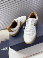 White and tan lace-up sneakers, front view with tan heel tab and gum sole
