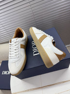 White Dior sneakers with tan side panels and lace-up front