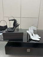 YSL ladies black and white strappy high-heel sandals on display boxes