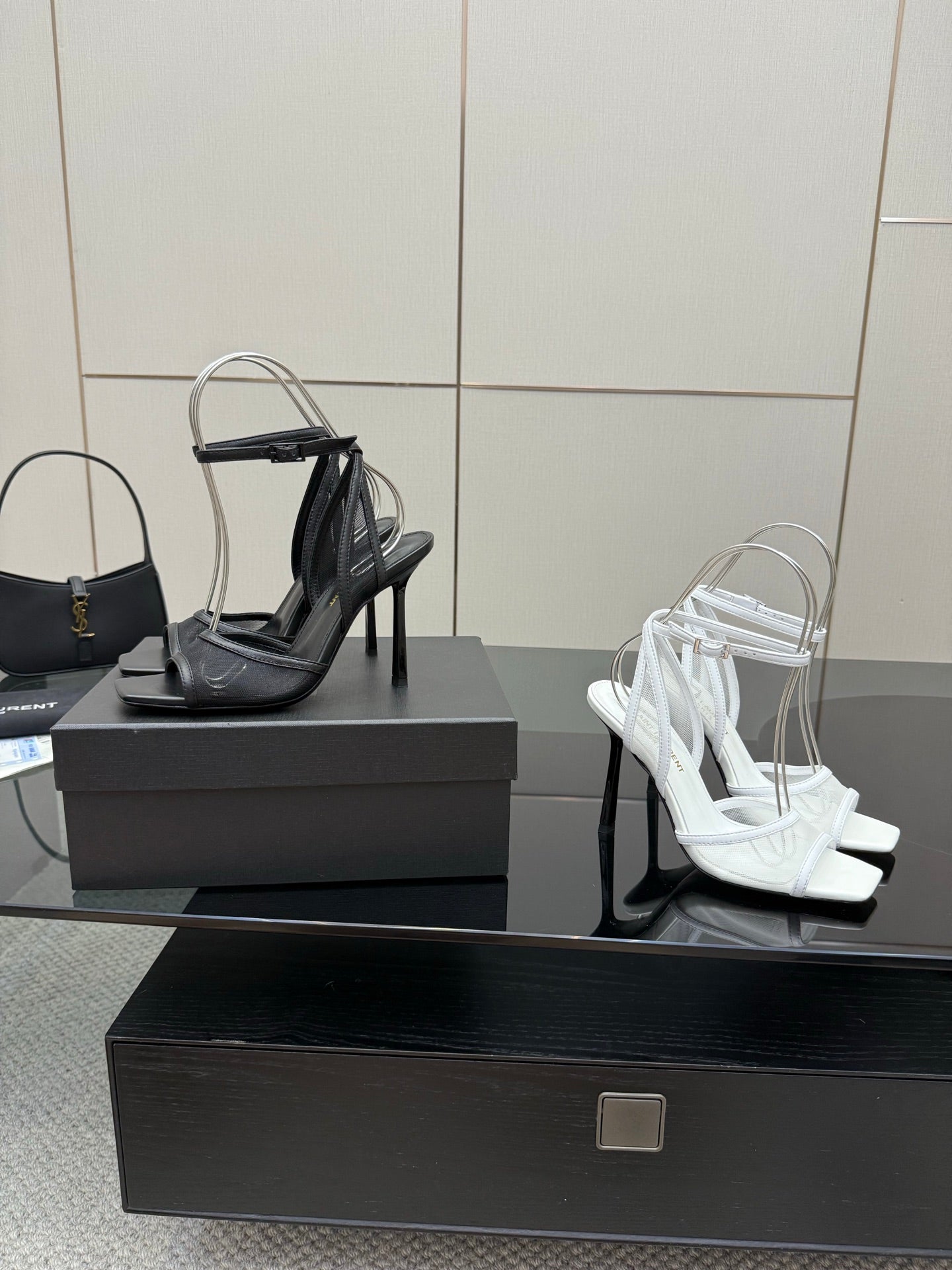 YSL ladies black and white strappy high-heel sandals on display boxes