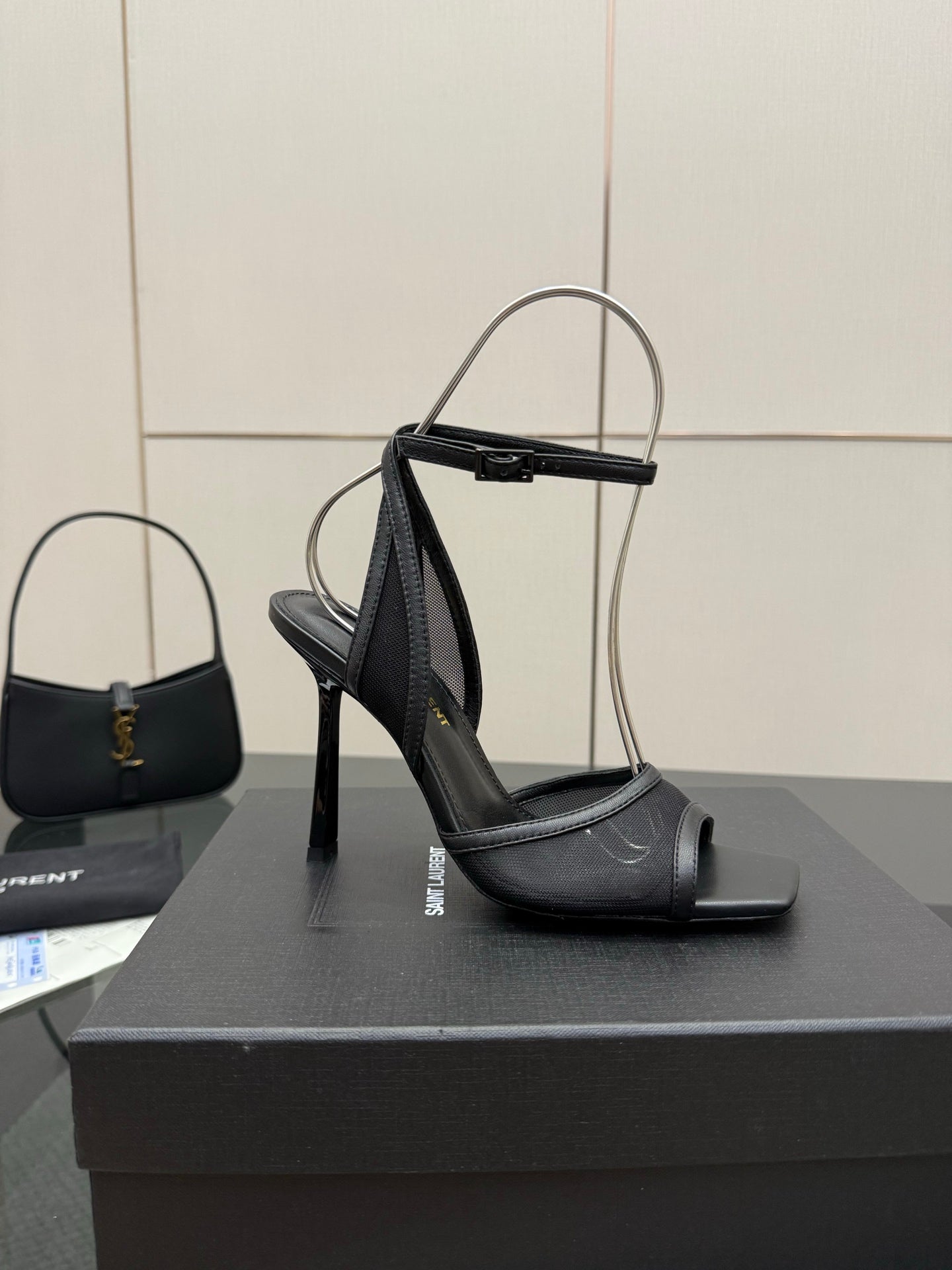 YSL ladies black strappy heeled sandals on a display box