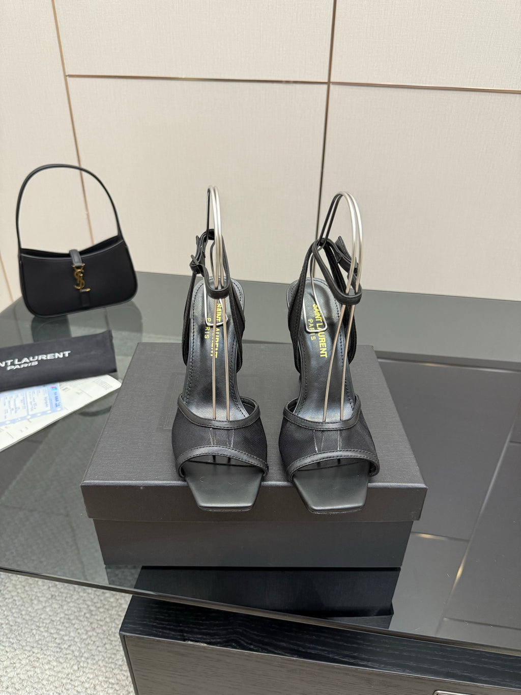 YSL ladies black strappy sandals, back view on a box