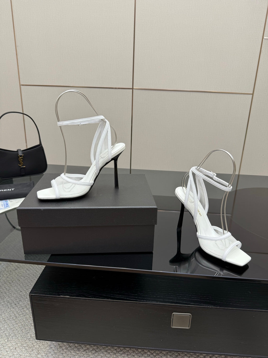 White women’s heeled sandals with open toe, ankle straps, and thin high heels