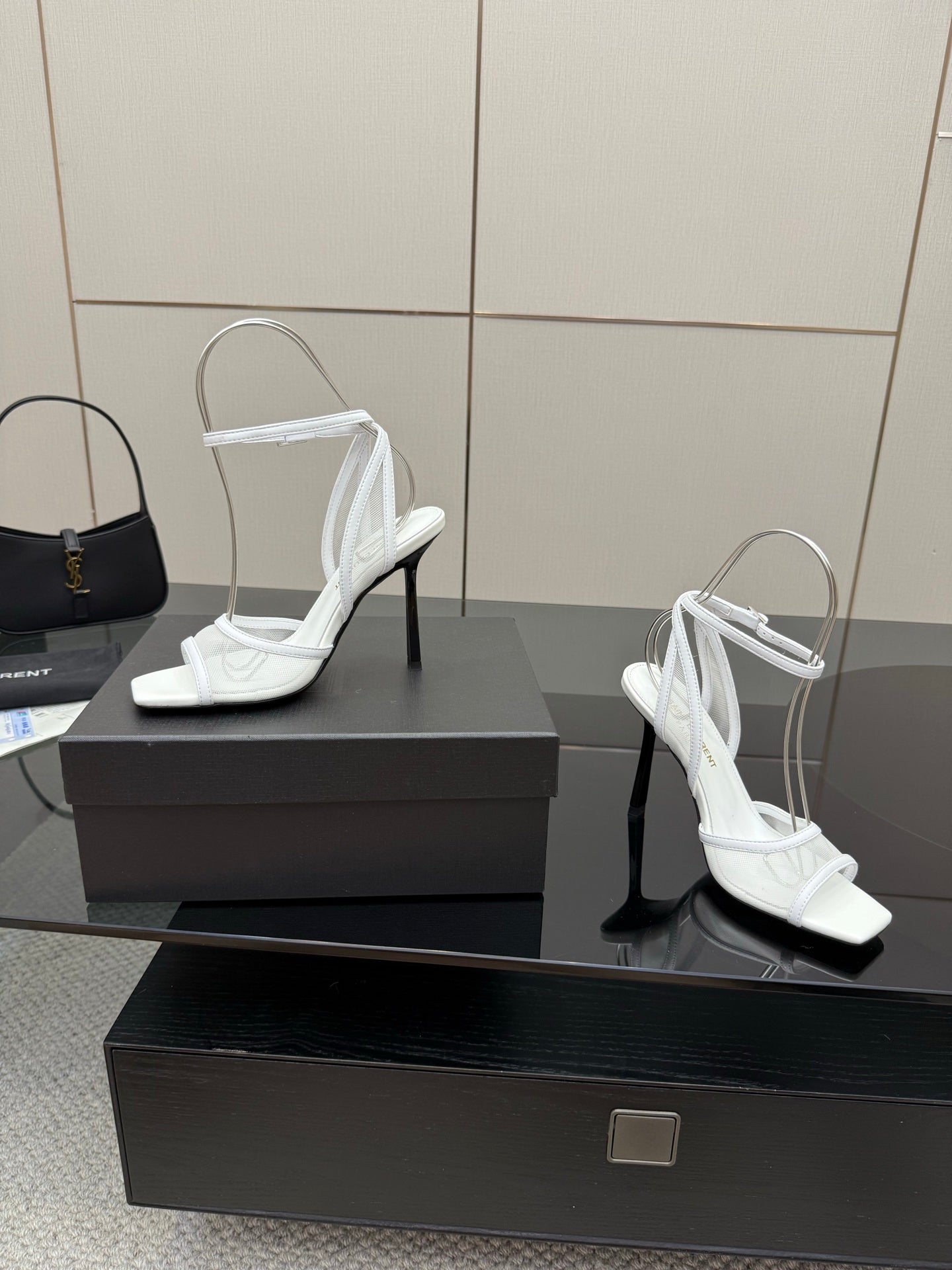 White women’s heeled sandals with open toe, ankle straps, and thin high heels
