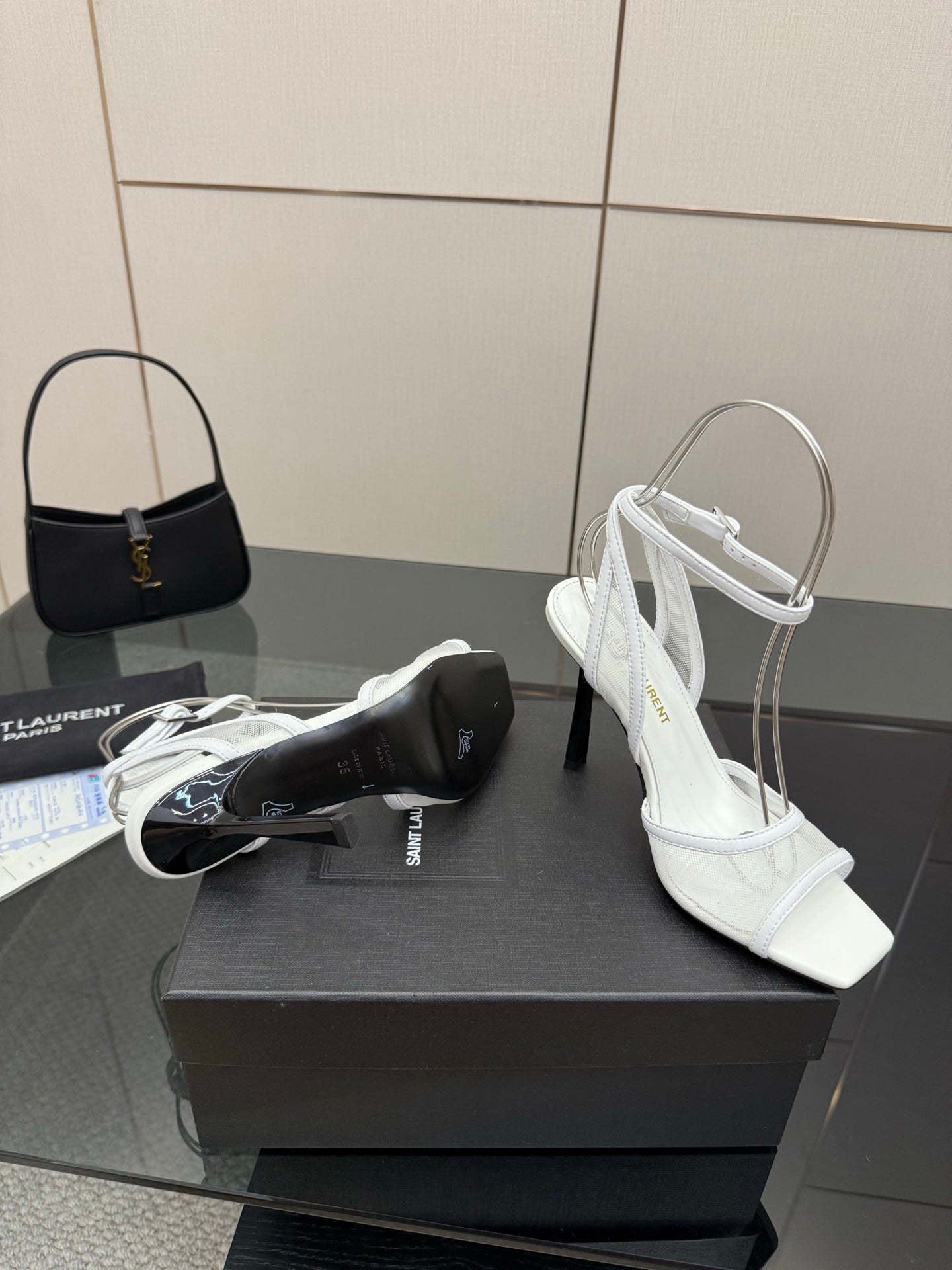 White women’s heeled sandal on box display, open toe and ankle strap