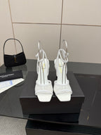Pair of white women’s heeled sandals with open toe and ankle strap, back view