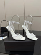 White women’s heeled sandal with open toe, ankle strap, and slingback-style fit