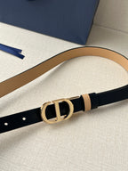 Narrow leather belt with navy face, tan stripe, and gold-tone CD buckle