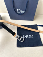 Leather belt with gold-tone CD buckle and navy strap with tan trim