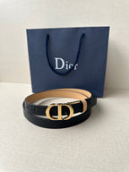 Leather belt with navy strap, tan stripe, and gold-tone CD buckle