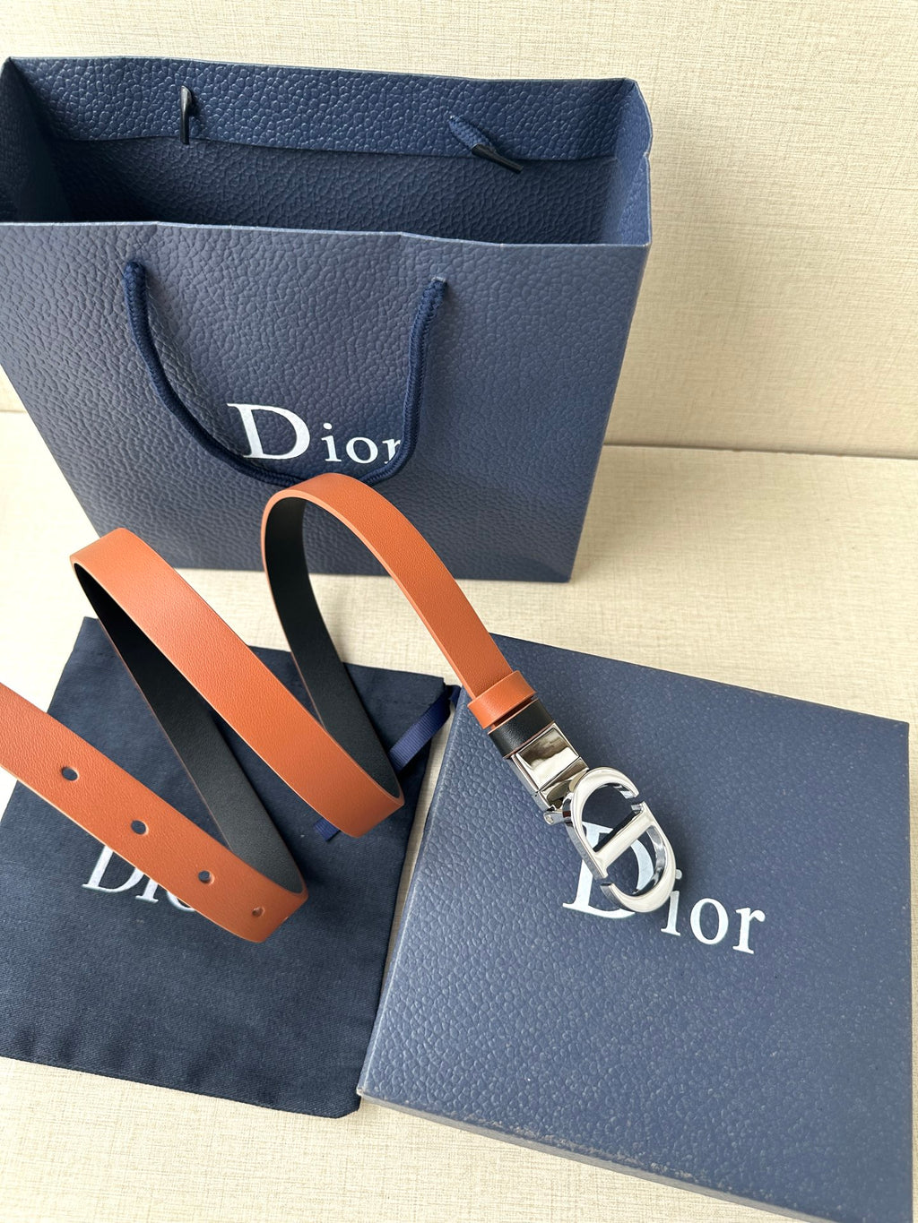 Dior leather belt with tan strap and large silver-tone buckle