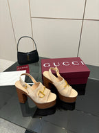 Women's Gucci cream platform mules with gold buckle detail and chunky block heel