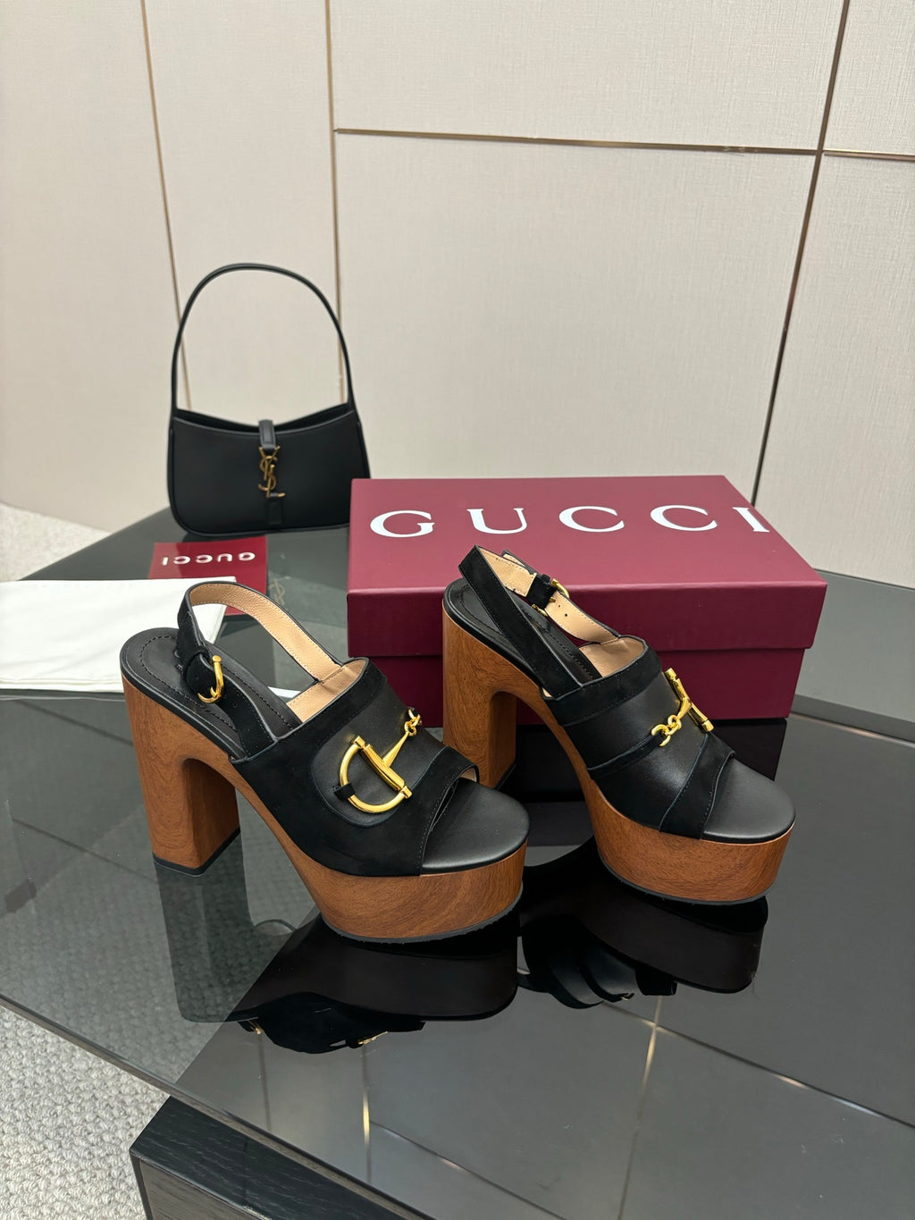 Gucci ladies black heeled sandals with gold buckle strap and thick wooden platform