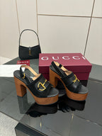 Gucci ladies black heeled sandals with gold buckle strap and thick wooden platform