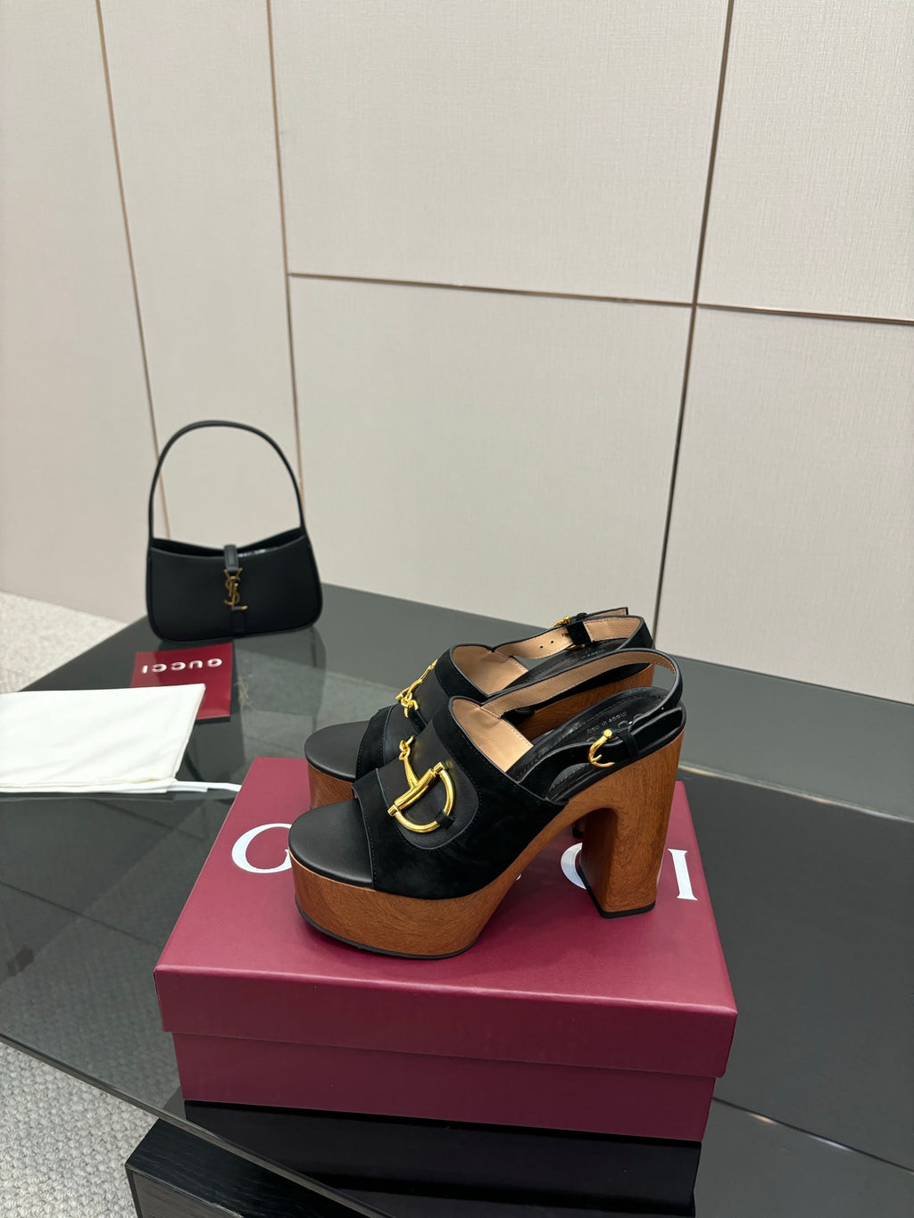 Gucci ladies black heeled sandals with gold-tone buckle detail and chunky wooden heel
