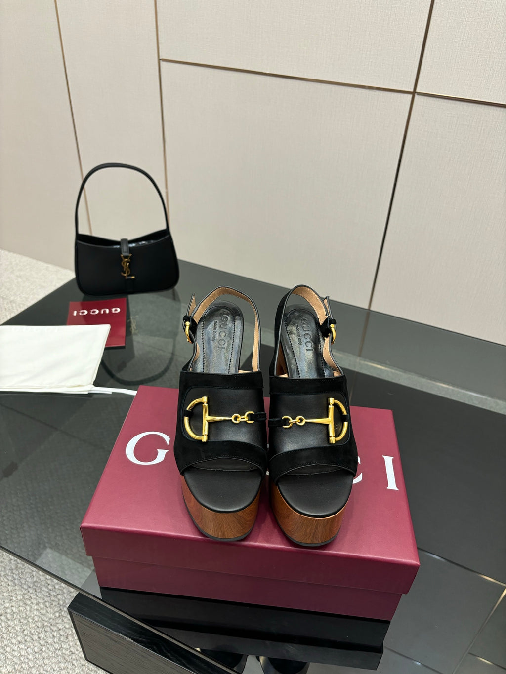 Gucci ladies black heeled sandals with gold-tone buckle straps and wooden platform