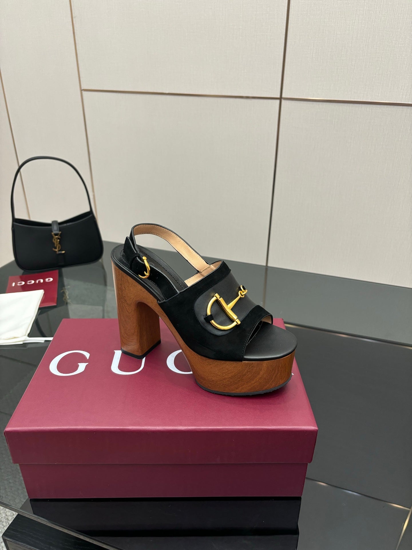 Gucci ladies black heeled sandal with gold buckle strap and wooden platform heel