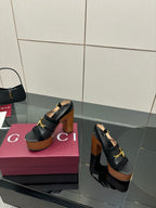 Gucci ladies black heeled sandals with gold buckle strap and wooden platform sole