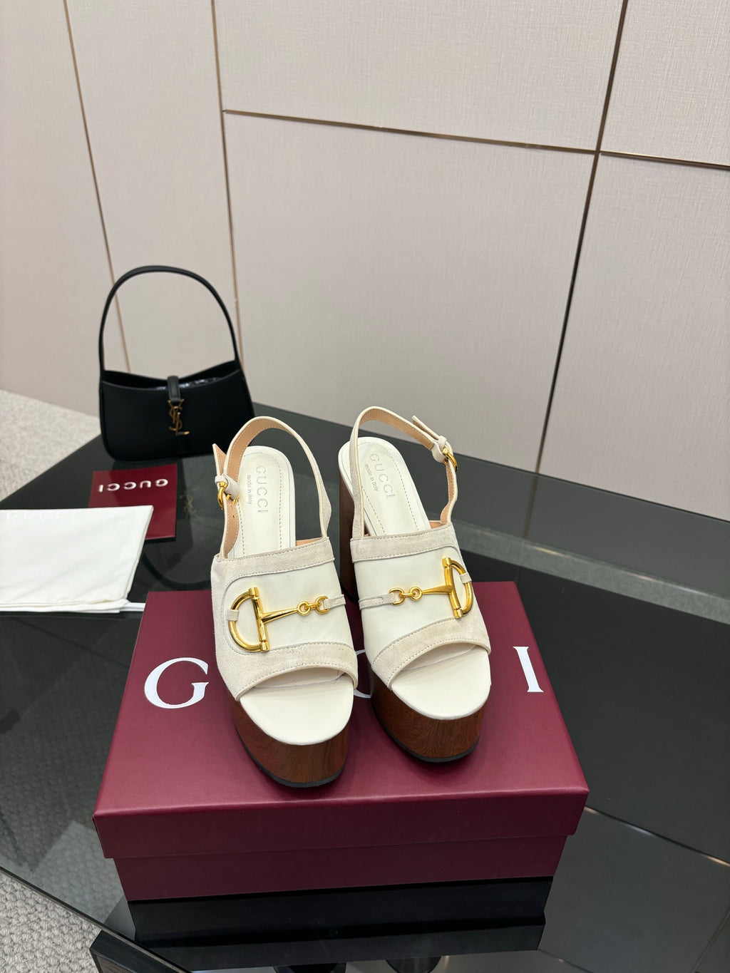 Pair of white heeled mules with gold buckle detail and chunky brown platform heel