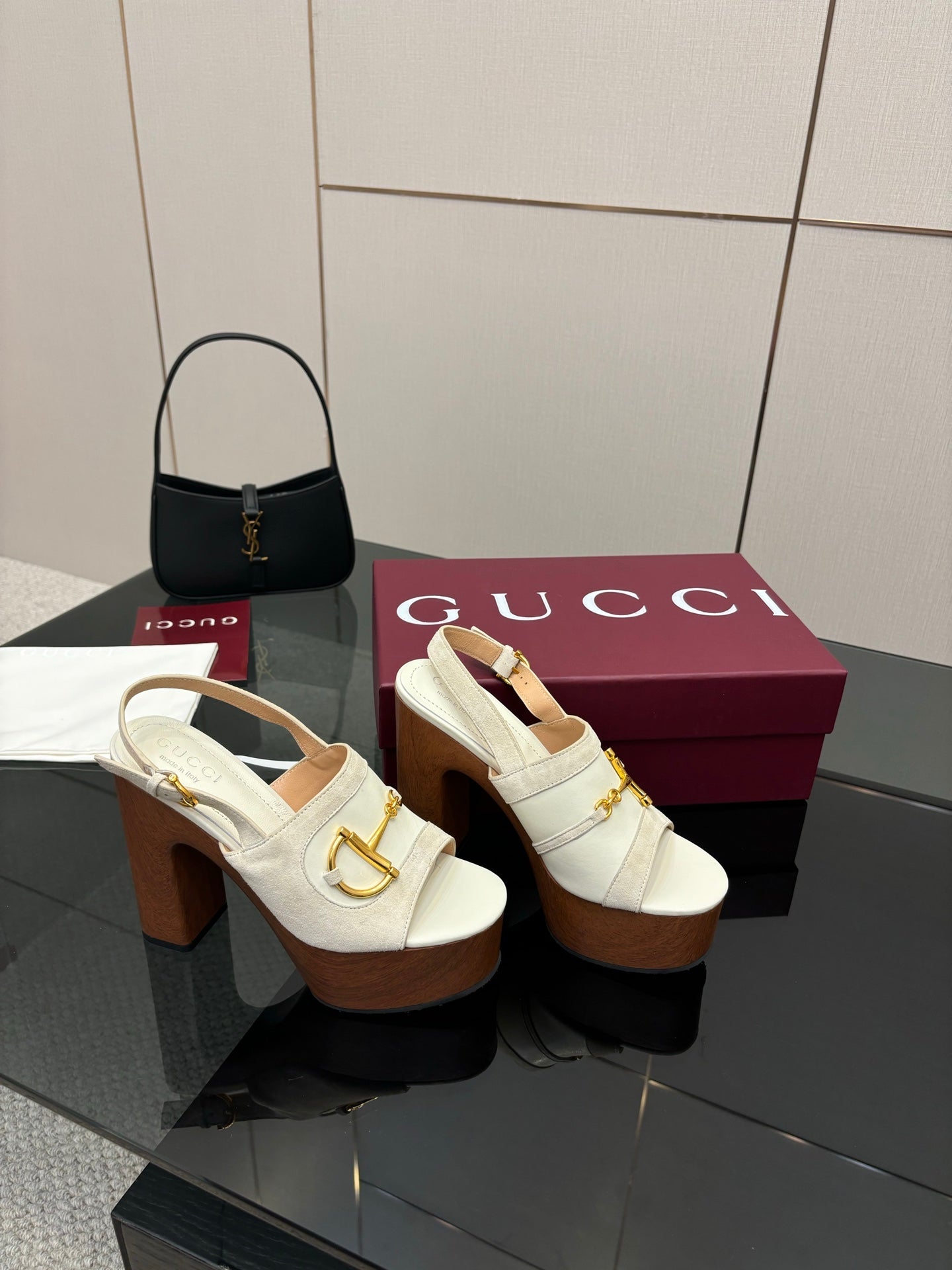 White mule sandals with gold buckle detail on open back and chunky brown heel
