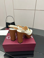 White heeled mules with gold buckle strap and tall chunky brown block heel