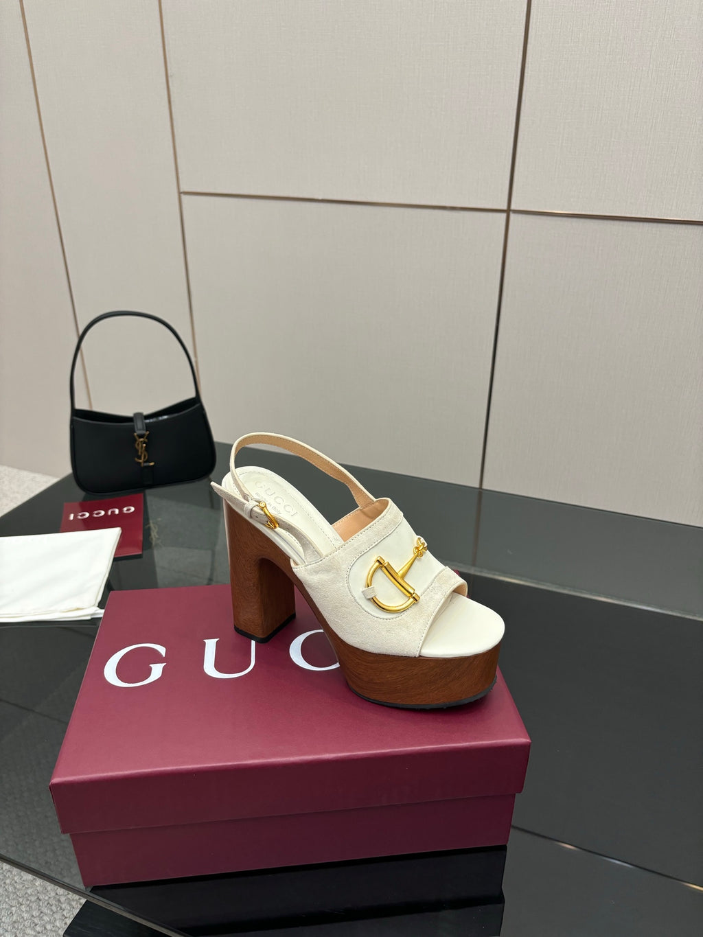 Single white mule sandal with gold buckle detail and chunky brown platform block heel
