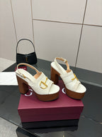 White mule sandals with gold buckle detail and chunky brown block heel, side view