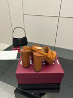 Women’s tan platform mule sandals with gold buckle details and tall block heel