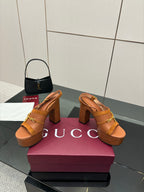 Women’s tan platform mule sandals with gold buckle straps and thick block heels