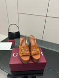 Women’s tan platform mule sandals with gold buckle hardware and chunky block heels