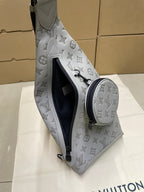 Men's Louis Vuitton monogram sling bag angled view, light gray/white with black zip