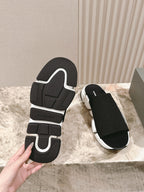 Black slide sandal outsole with Balenciaga logo and white midsole.