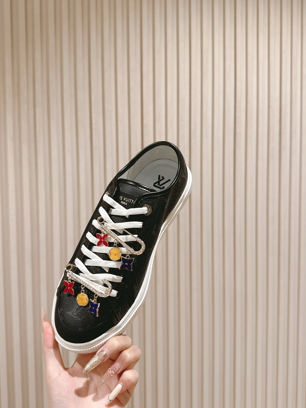 Louis Vuitton unisex sneakers, black low-top with white laces and charm details