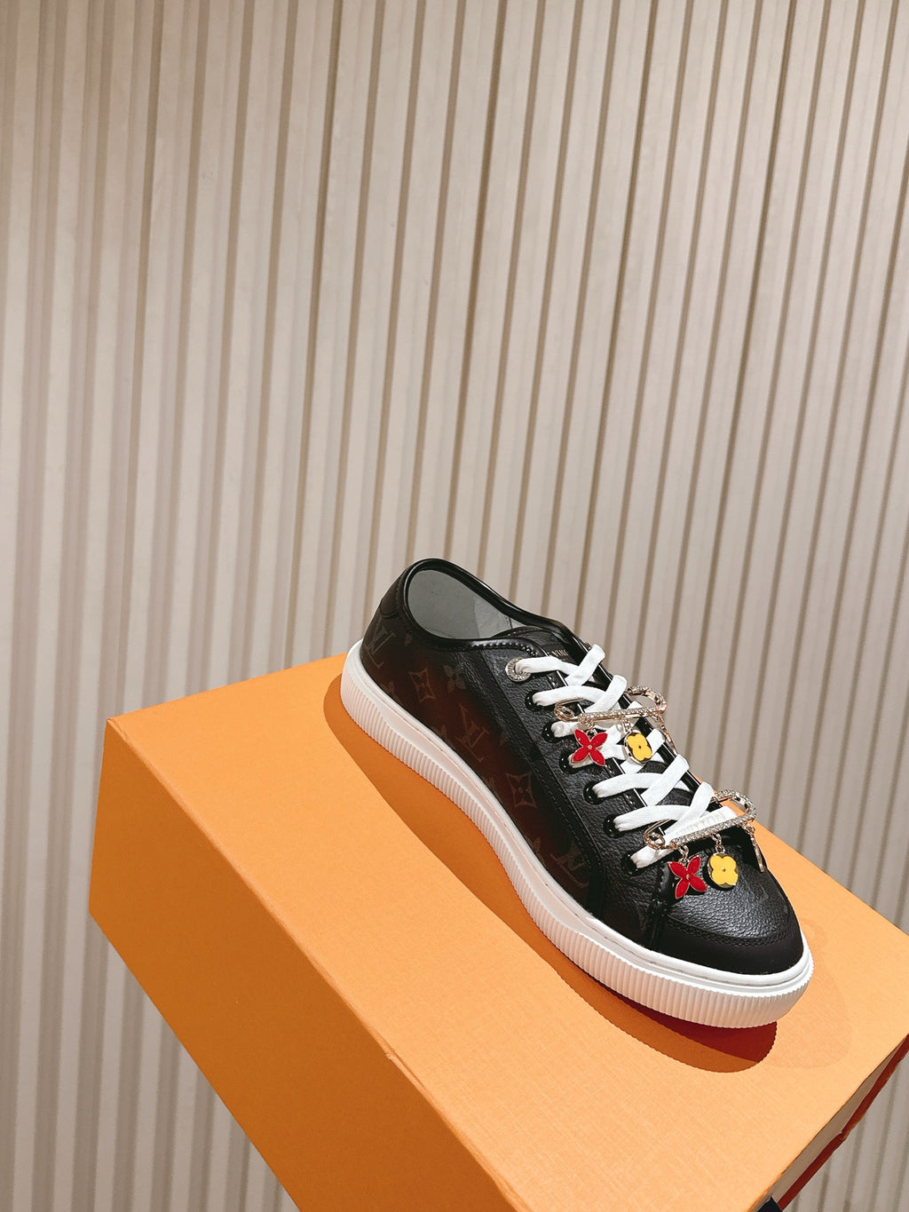 Louis Vuitton unisex sneakers, black on orange box with white sole and charms