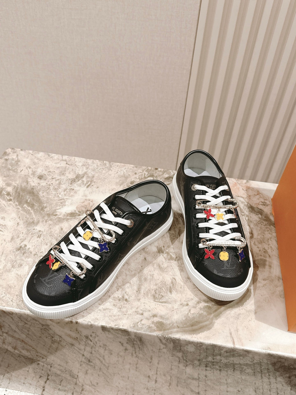 Louis Vuitton unisex sneakers, black pair with white soles and lace charms
