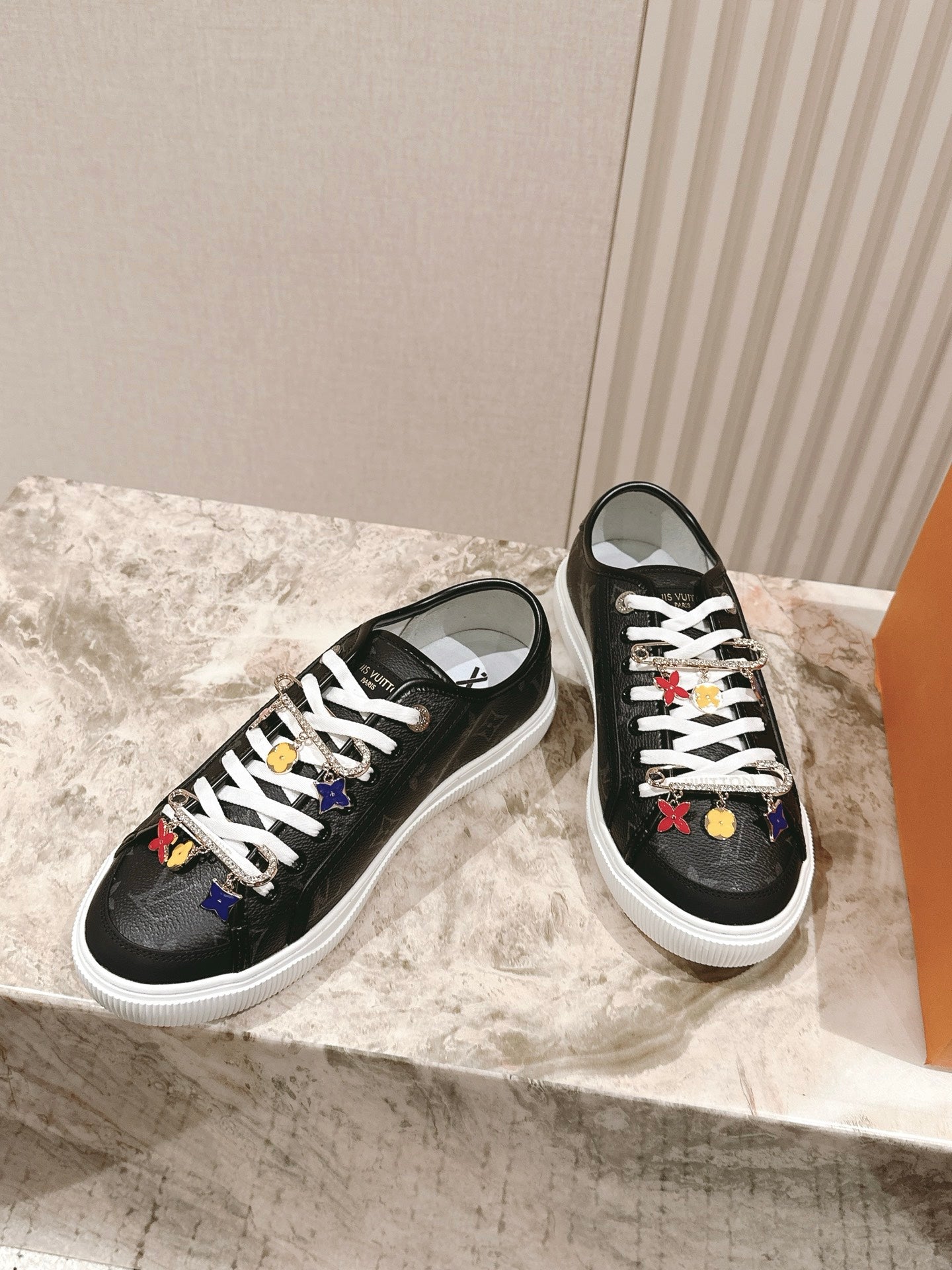 Louis Vuitton unisex sneakers, black pair with white soles and lace charms