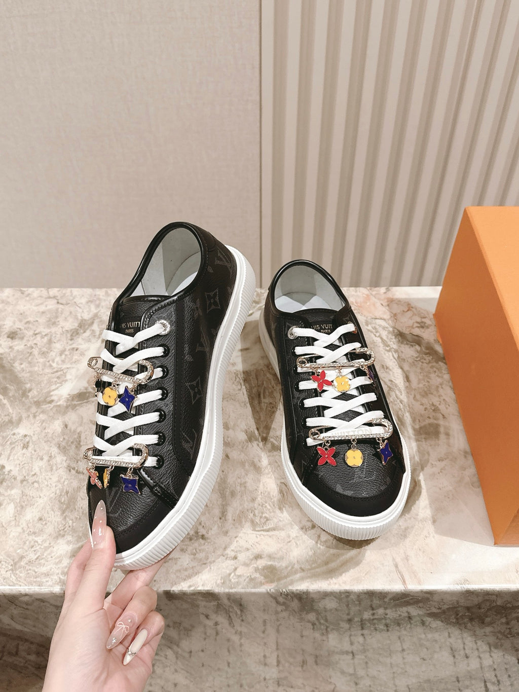 Louis Vuitton unisex sneakers, black side view with white laces and charms