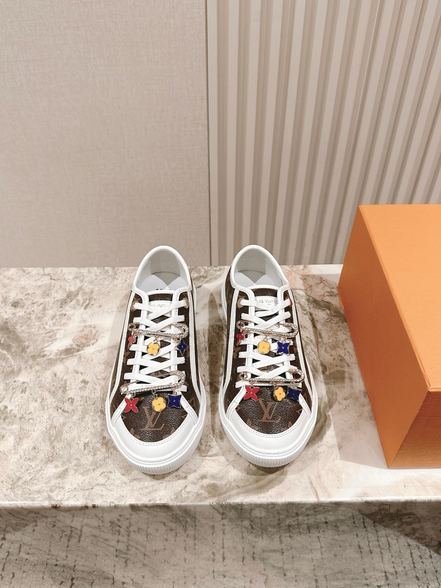 Pair of Louis Vuitton low-top sneakers, brown canvas with white laces and colorful motifs