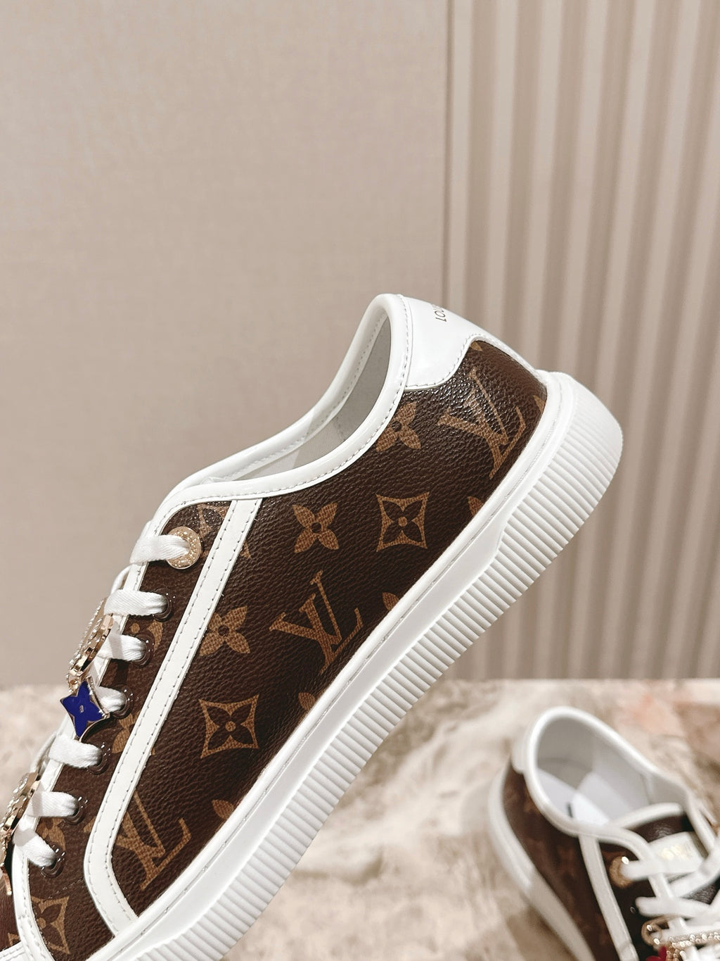 Louis Vuitton low-top sneaker, brown monogram canvas with white trim and lace-up front