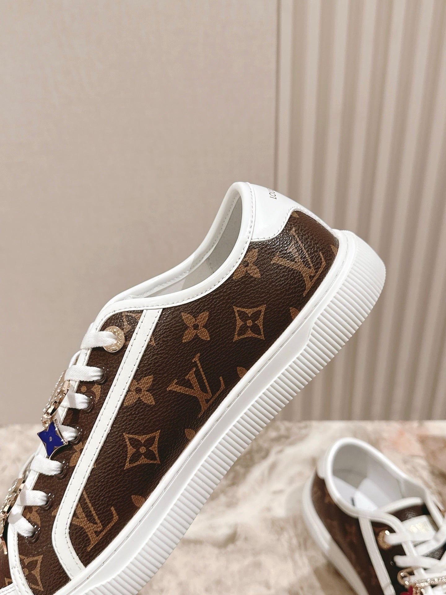 Louis Vuitton low-top sneaker, brown monogram canvas with white trim and lace-up front