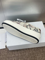 White unisex sneaker with botanical print upper and dark edge on sole