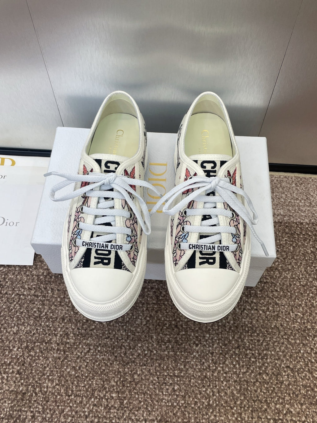 White unisex low-top sneakers with floral print panels and white laces